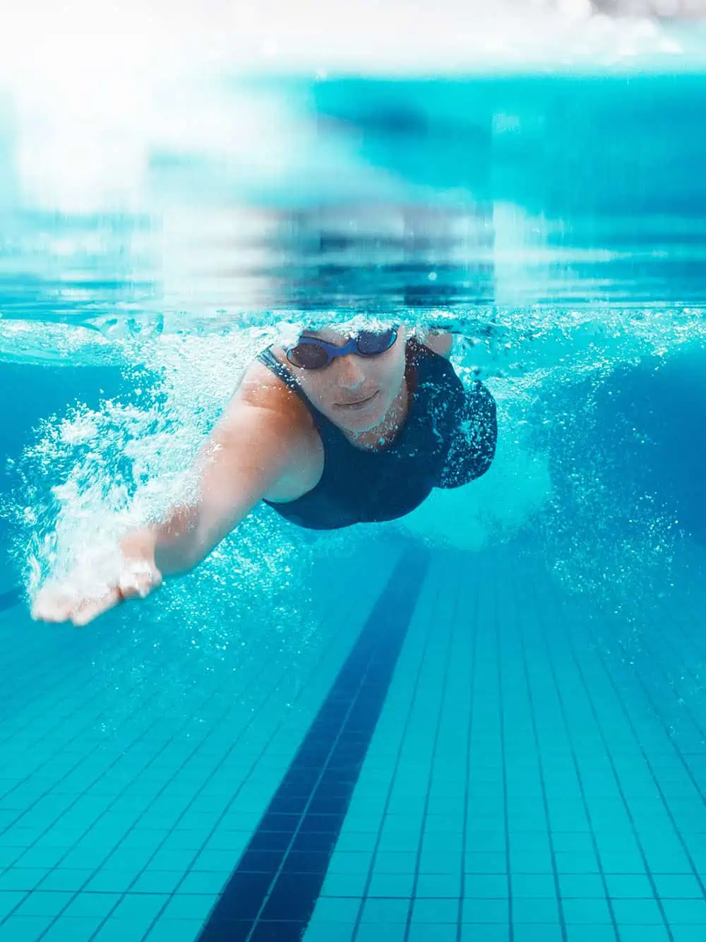 Underwater view of woman swimming freestyle